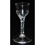 A late 18thC Georgian wine glass, the plain bowl raised on a faceted stem and conical foot, 13.5cm h