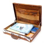 Masonic collectables, including an apron, books and ephemera, in a tan leather case.