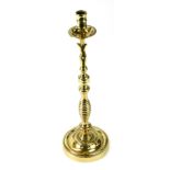 A brass taper candlestick, 47cm high.