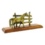 A novelty letter rack, with brass horse and fence post, on a stepped wooden base, 14cm high, 25cm wi