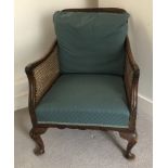 A walnut bergere salon chair, with cane back on cabriole legs, 92cm high.