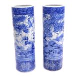 A pair of Japanese blue and white stick stands, each with a bird of prey and floral spray design, un