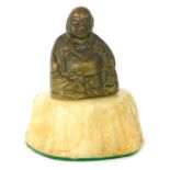 A brass Buddha paperweight, on an alabaster cream base, 12cm high.