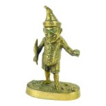 A Victorian brass novelty ink well modelled as Mr Punch, in standing pose, holding a quill and ink w