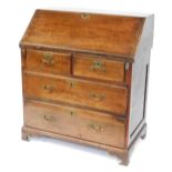 An early 19thC oak bureau, the fall above one short and two long drawers, on bracket feet, 98cm high