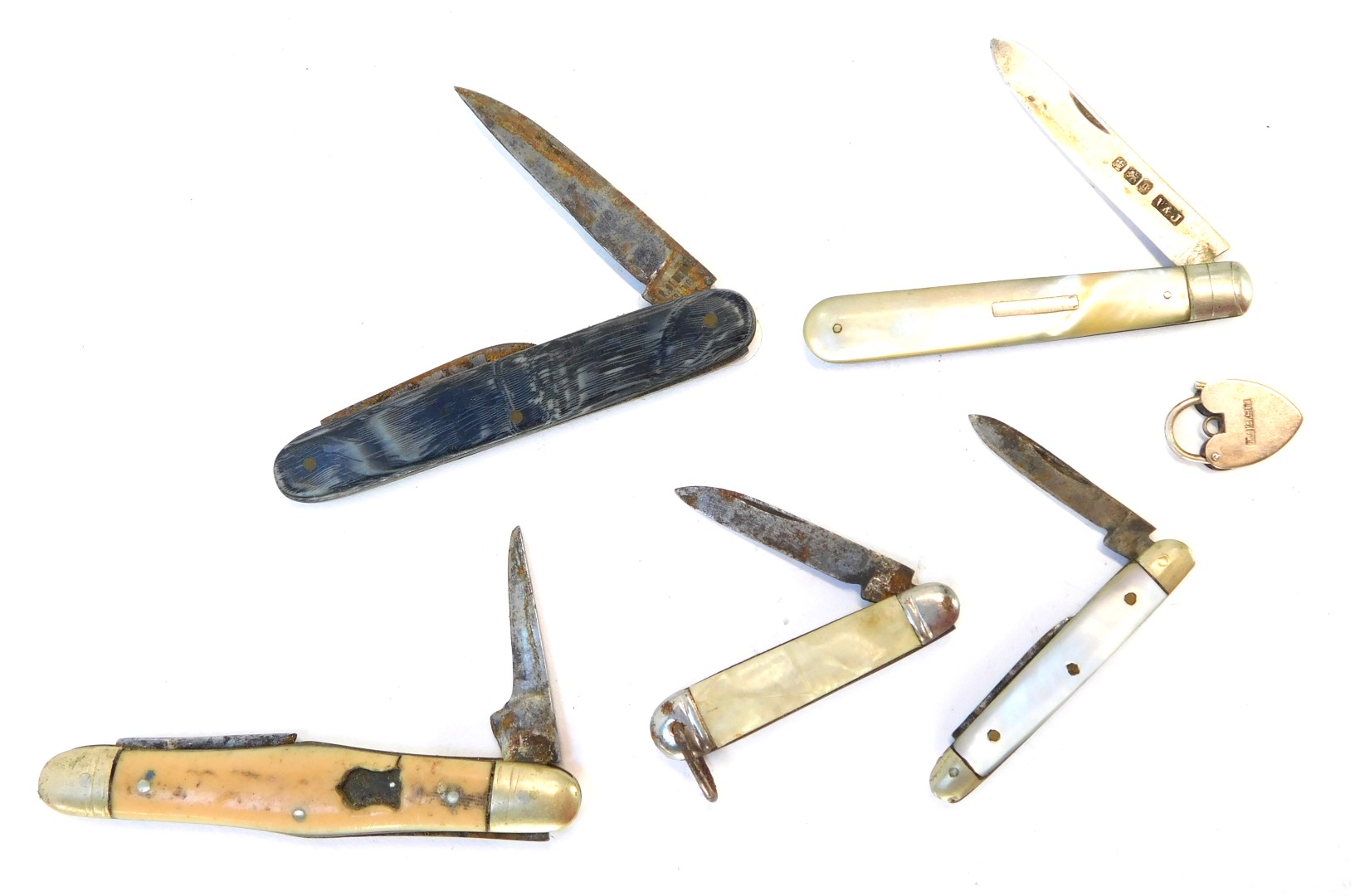 A group of penknives, comprising a silver and mother of pearl handled penknife, two imitation mother