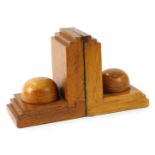 A pair of 1960s/70s carved oak book ends, each with graduated ends, and central dome, 14cm high.