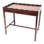 A Georgian style flamed mahogany tray top silver table, with a shaped gallery, on tapering legs, 73c