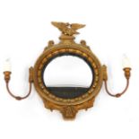 A gilt girandole mirror, with an eagle crest, and bow and feather detail, with convex mirror and two