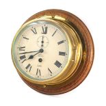 A Sestrel early 20thC brass cased ships bulkhead clock, for Olsen's of Grimsby, circular dial bearin