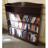 A mahogany open bookcase, with shaped sides and a plinth, 113cm high, 107cm wide, 20cm deep.