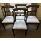 A set of four William IV mahogany dining chairs, with overrun cresting rails, drop in seats and reed