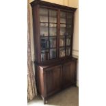 A George III mahogany cabinet, with a moulded cornice above two astragal glazed doors, the base with