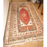 An Eastern rug, with geometric cream and red design.