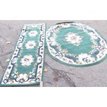 Two Chinese wool cut rugs, one oval one runner, in green with floral design. (2)