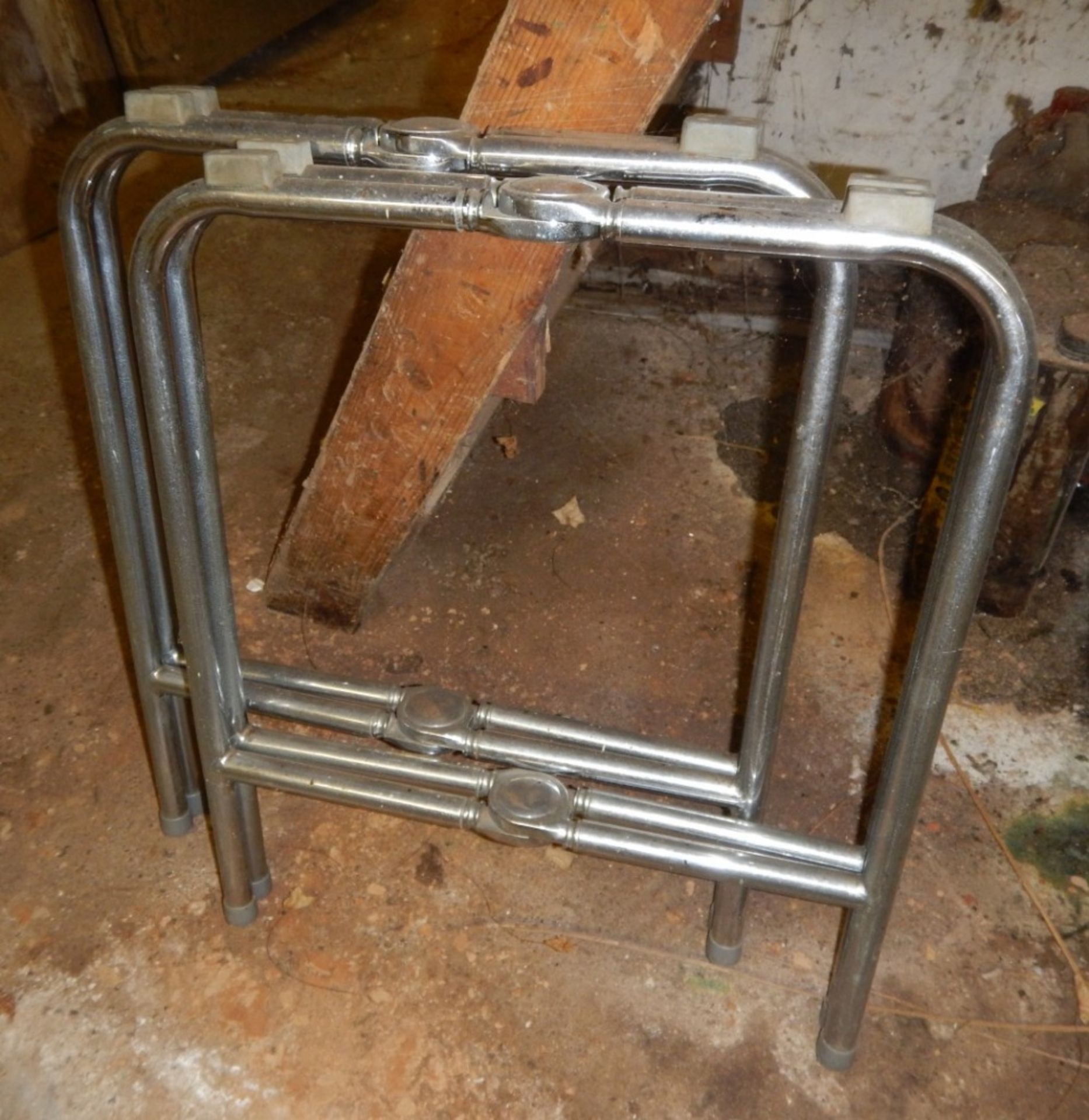 Pair of folding metal coffin trestles.