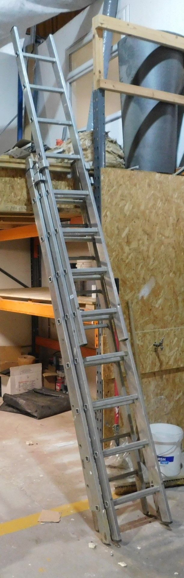 An extending ladder. VAT is also payable on the hammer price of this lot.