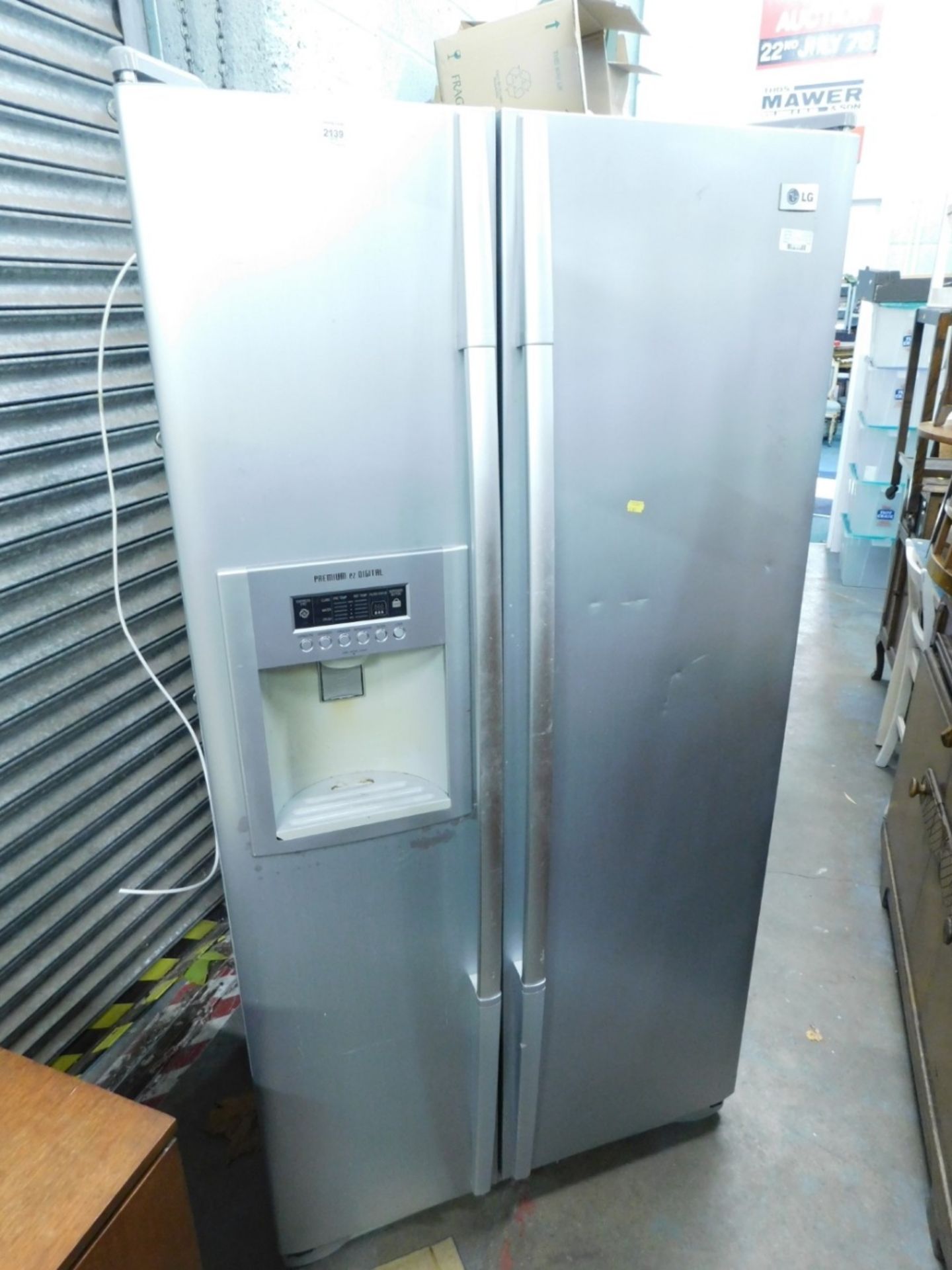 An LG American style fridge/freezer with water dispenser.