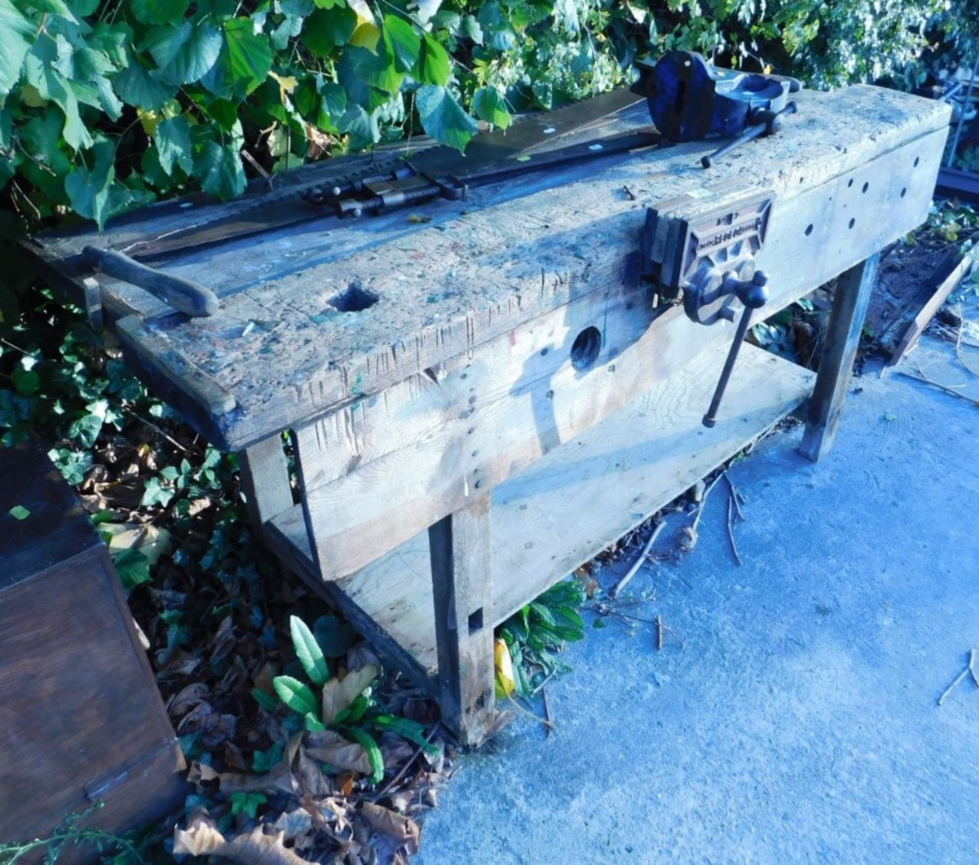 An early 20thC rustic work bench, with attached Trade Reeded number two vice, loose vice, large top