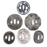 Six Japanese tsuba, of varying shapes and designs, depicting dragon, waves, blossom, etc., 7.5cm dia