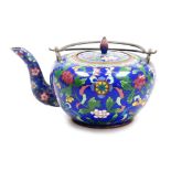 A late 19thC Chinese cloisonne teapot, with double loop brass handle, decorated with flowers and pre