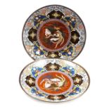 A pair of Japanese Meiji period cloisonne chargers, each decorated centrally with a phoenix surround