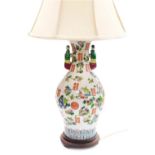 A late 20thC Chinese famile rose porcelain table lamp, of twin figural handle baluster form, decorat