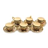 A set of six Satsuma pottery teacups and saucers, each with a gilt highlighted moulded chilin handle