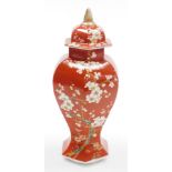 A late 19thC Japanese porcelain vase and cover in the Chinese style, of faceted baluster form, decor