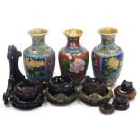 A pair of Chinese cloisonne vases, each of baluster form decorated with panels of flowers against a