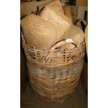 A wicker log basket, with four ring handles, 87cm high, containing a quantity of woven wicker basket