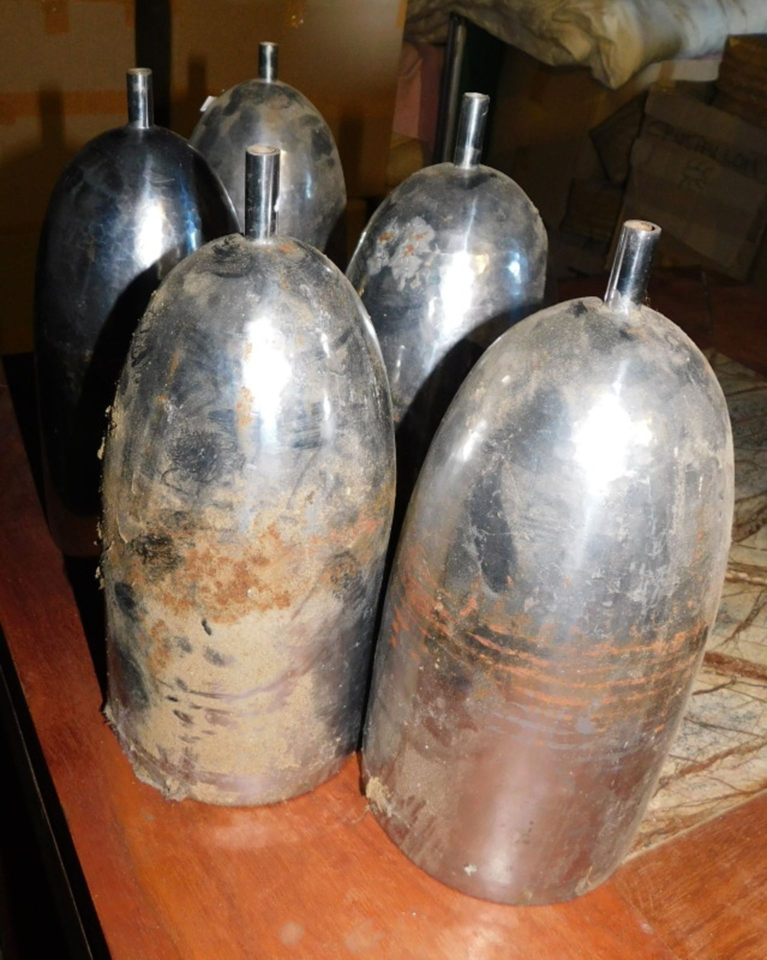 Five hammered metal light shades, of cylindrical elongated form, with copper coloured interior, 29cm