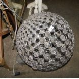 A hanging light fitting, of globular form, inset with various faceted crystals, approx 140cm drop.