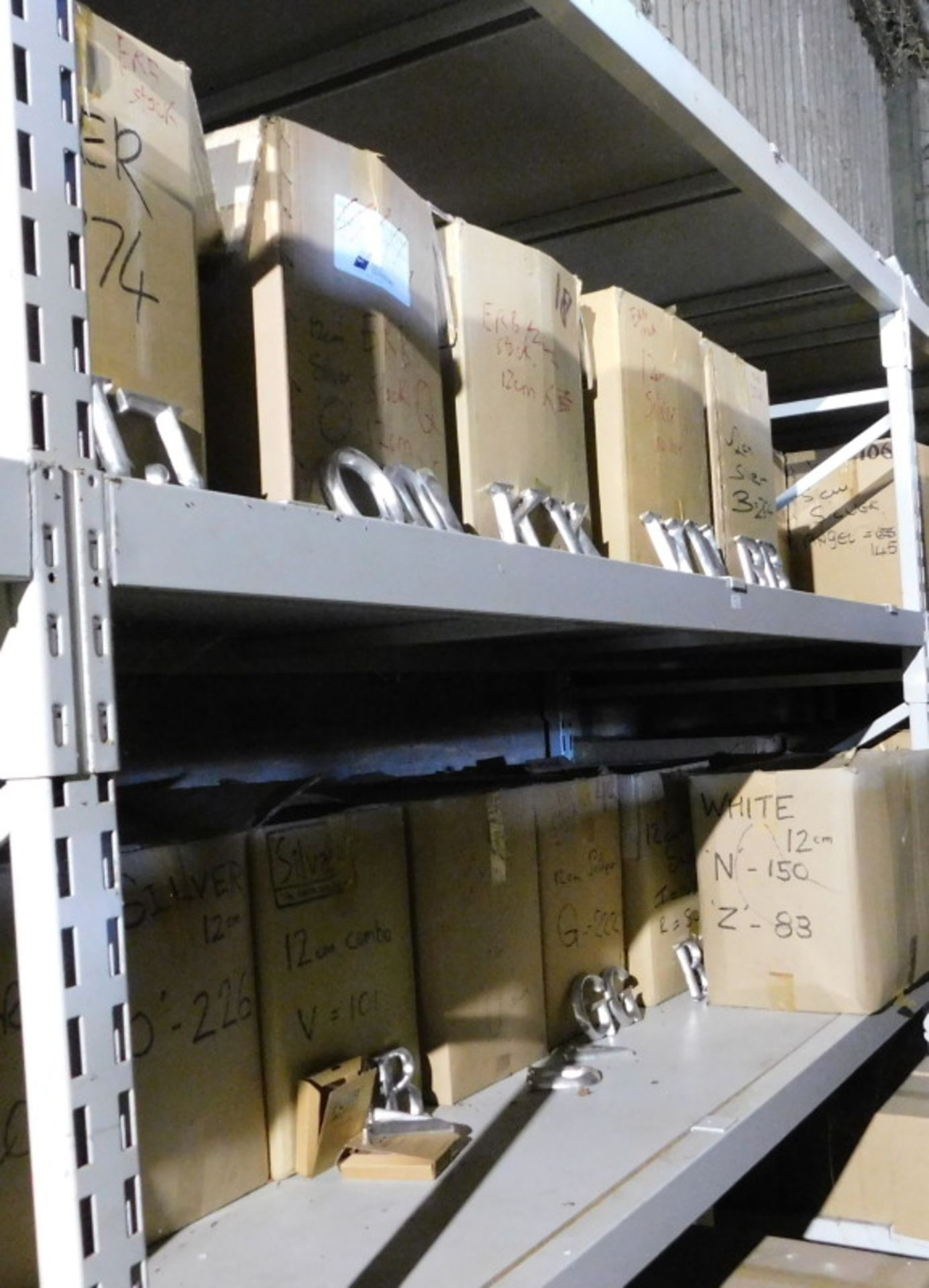 A group of silver coloured carved wooden letters, to include J, K, W, G, each 12cm high. (2 shelves)