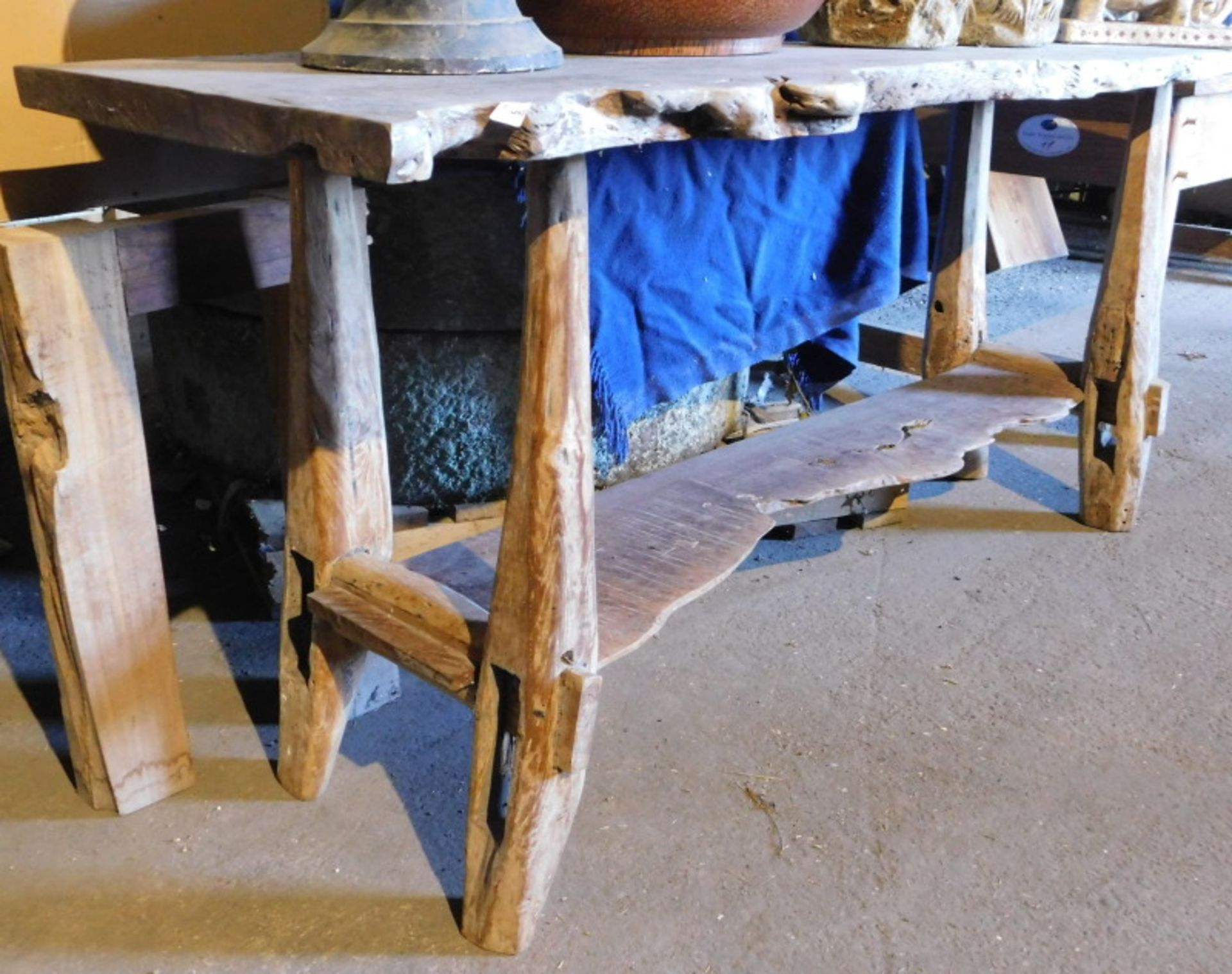 A driftwood two tier side table, 83cm high, the top approximately 59cm x 190cm. Note: VAT is payable
