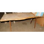 A reclaimed teak coffee table, the top of shaped form on cylindrical tapering legs, 52cm high, the t