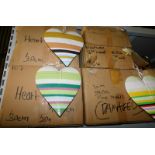 A group of painted wooden heart hanging decorations, each in differing colours of stripes, 30cm and