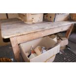 A reclaimed pine kitchen table, with a rectangular top, on strut supports, 74cm high, the top 80cm x