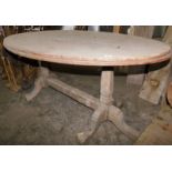 A reclaimed hardwood dining table, the top of oval form, on turned legs united by a stretcher, 82cm