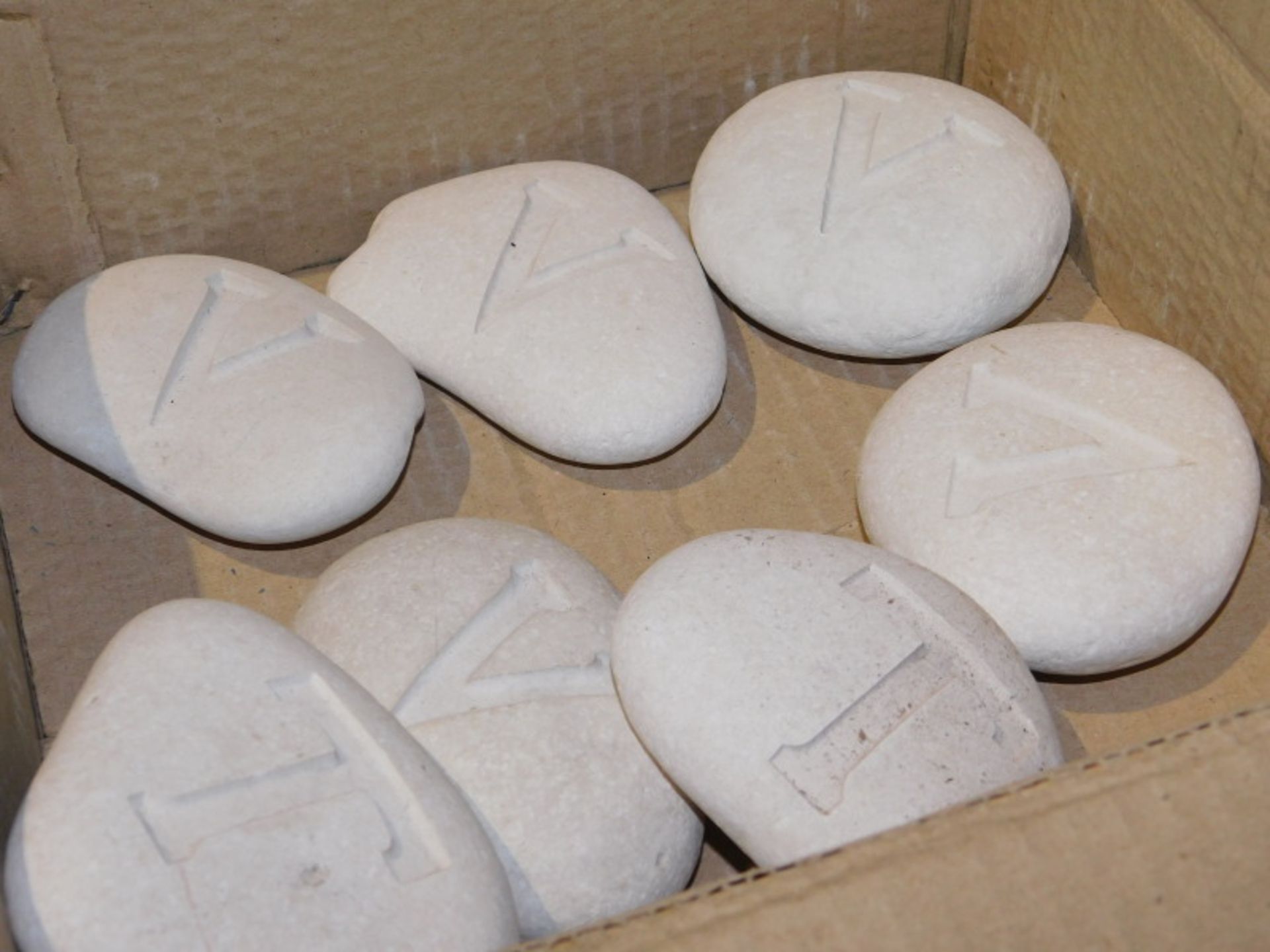 A group of polished rocks, with letters carved to each, to include Z, H, X, W, etc. Note: VAT is pay