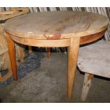 A reclaimed teak dining table, with circular top, on tapering legs, 76cm high, the top 110cm diamete
