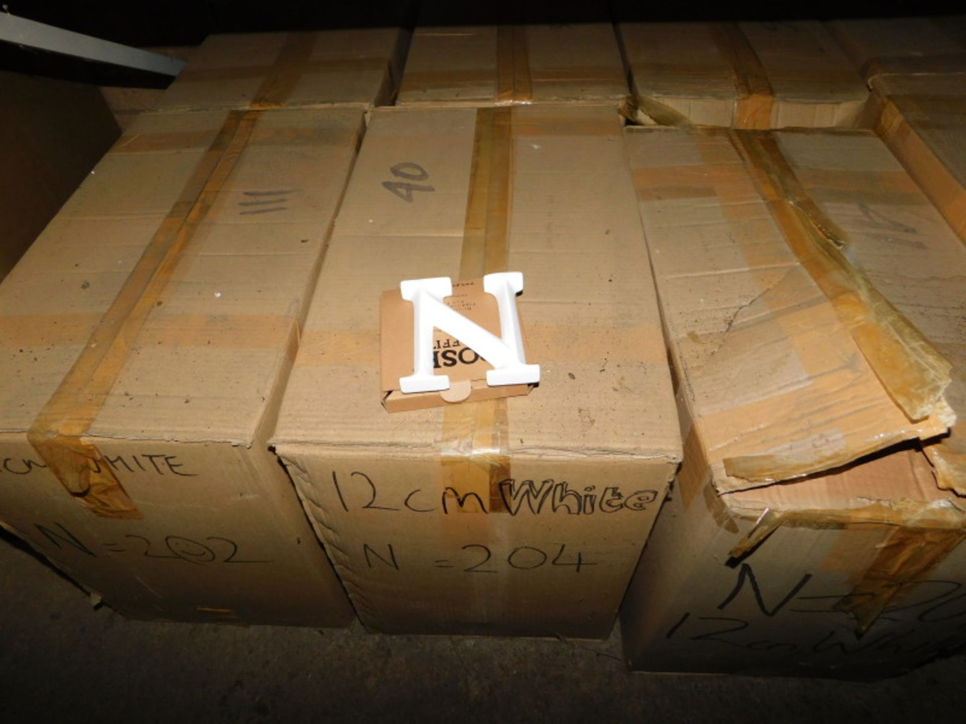 A group of white coloured carved wooden letters, to include N, each 12cm high. (6 boxes) Note: VAT i