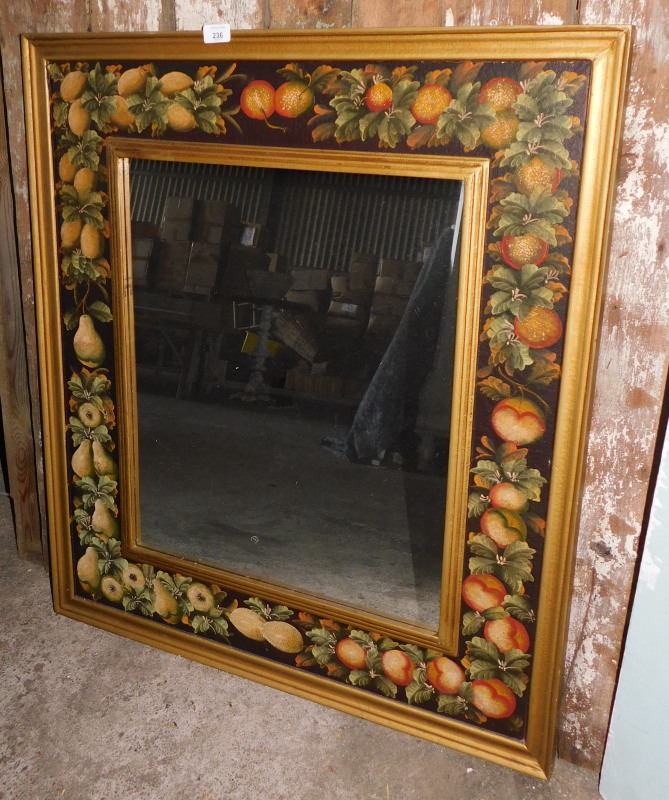 A wall mirror, the frames painted with fruit with a gilt inner and outer border, 93cm x 82cm. Note: