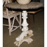 An occasional table, with a reclaimed wood shaped circular top, on a painted white cast metal base,