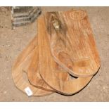 Four reclaimed teak chopping boards, each with a cut out handle, the largest 40cm x 27cm. Note: VAT