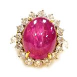 A cabachon ruby and diamond ring, the central high cabachon (highly included) of 13.4mm x 10.1mm, su