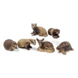 Six Poole buff pottery figures of animals, comprising two badgers, a guinea pig, a fawn, hedgehog an
