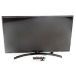 An LG 43" flat screen television, LG43UK6400PLE, with remote and instructions.