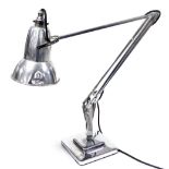 An Anglepoise model 1227 chrome and aluminum desk lamp, designed by Herbert Terry, raised on a stepp