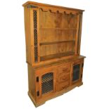 An Eastern hardwood and cast iron mesh kitchen dresser, the outswept pediment over two shelves, abov